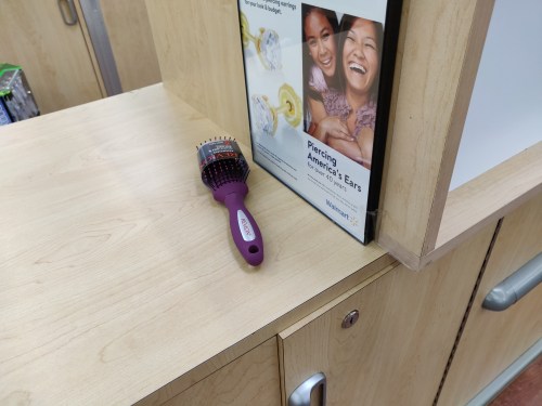 Abandoned Revlon hair brush on a counter