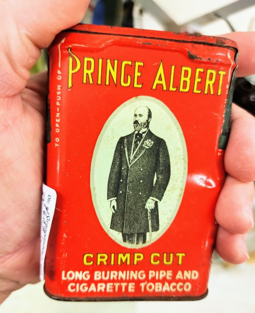 can of the tobacco in hand