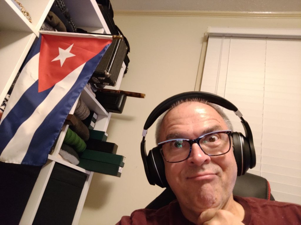 selfie wearing headphones and CU flag to side