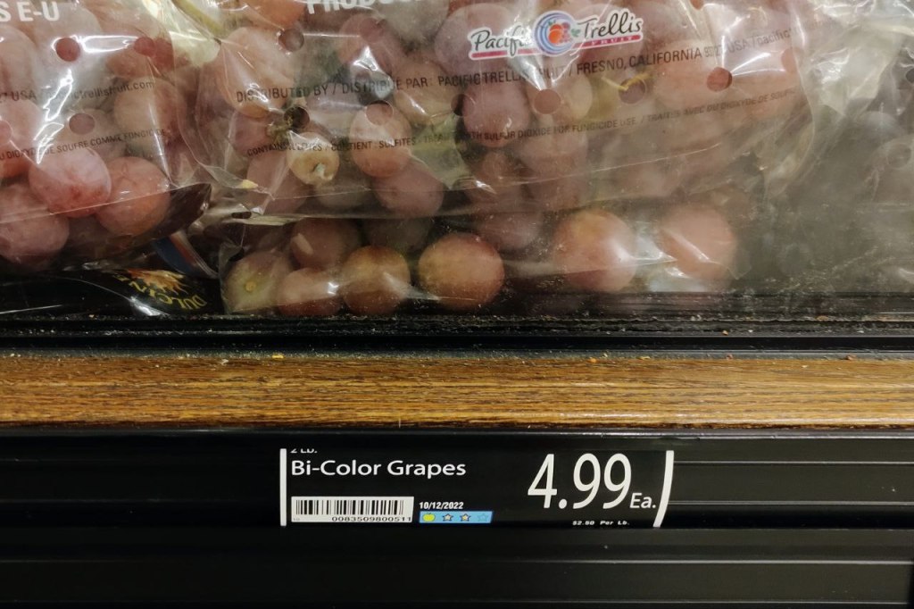 bags of grapes in store display with sign "bi-color grapes"