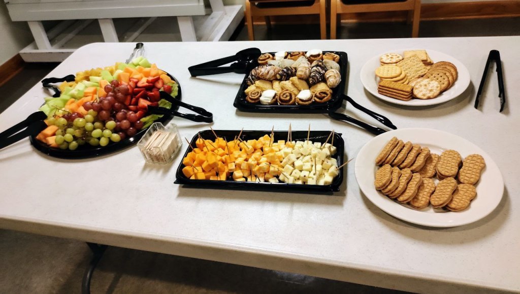 fruit, cheese, pastry, cookie, cracker snack trays on a table