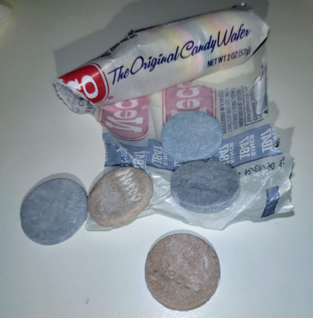 open roll of necco candy with bad ones pulled out on counter