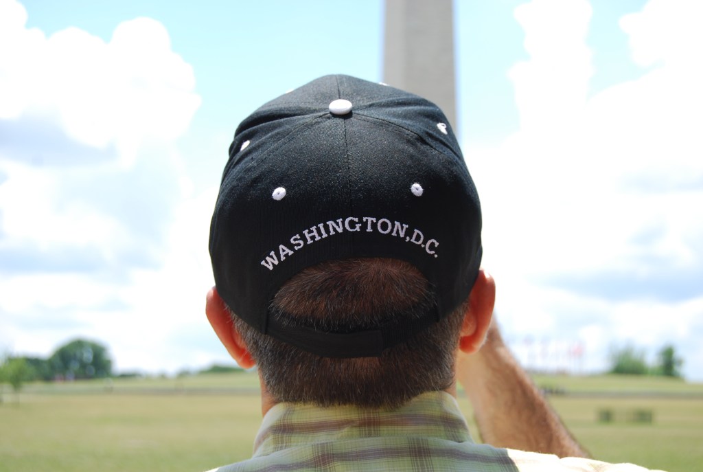 back of my head with washington dc cap on and washington monument in distance